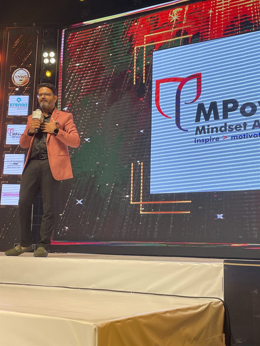 Pankkaj on stage at an MPower Mindset Academy event
